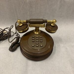 A brown and gold telephone sitting on top of a table.