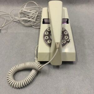 A telephone with cords attached to it.