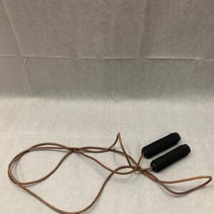 A pair of black and brown jump ropes on the floor.