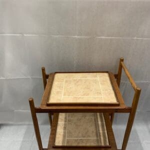 A wooden table with two trays on top of it.