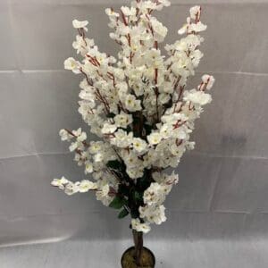 A white flower tree in a brown vase.