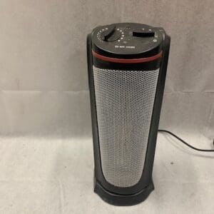 A black and silver heater sitting on top of the floor.