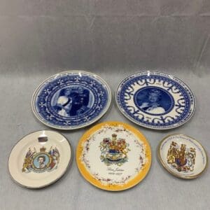 A group of six plates with different designs on them.