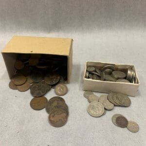 A box of coins and some quarters are on the floor.