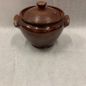 A brown pot sitting on top of a table.