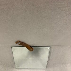 A wooden handle on the ceiling of a room.