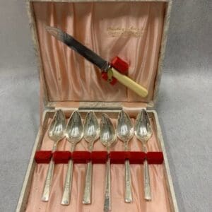 A set of eight silver plated spoons and forks.