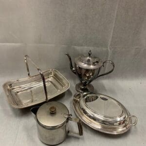 A group of silver plated items on display.