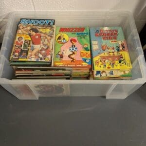 A bin of comics is shown with a few other books.