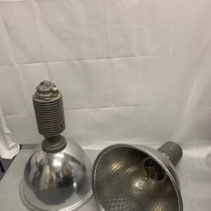 A pair of silver lamps on top of a table.