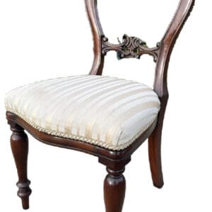 A chair with white seat and wooden legs.