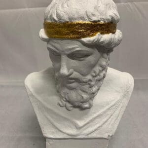 A bust of an ancient greek god with gold trim.