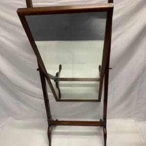 A wooden mirror stand with a glass top.