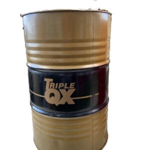 A barrel of triple qx oil sitting on top of a table.