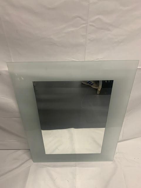 A mirror with a glass frame on it.