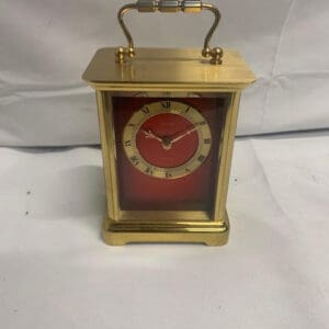 A small clock sitting on top of a table.