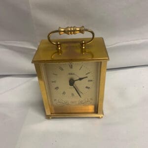 A small clock sitting on top of a table.