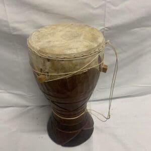 A brown and white drum sitting on top of a table.