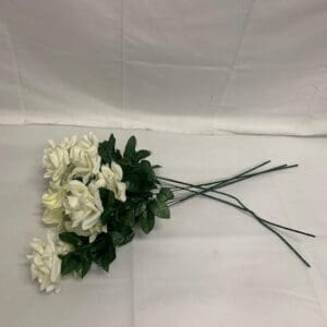 A white flower laying on top of a table.