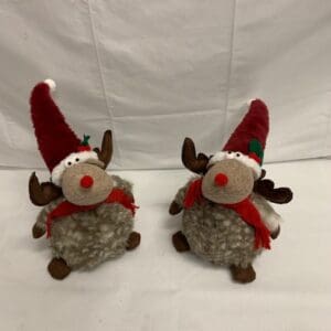 Two plush reindeer in Santa hats.