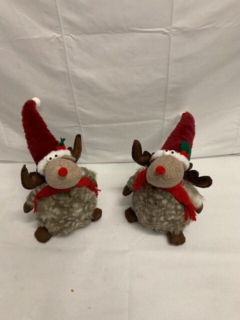 Two plush reindeer in Santa hats.