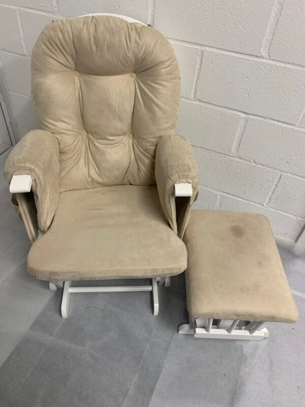 Beige rocking chair with ottoman.