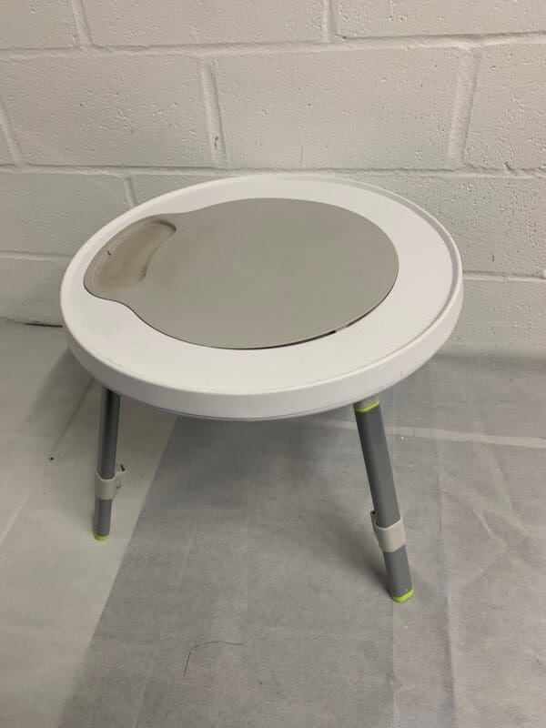 White round activity table with tray.