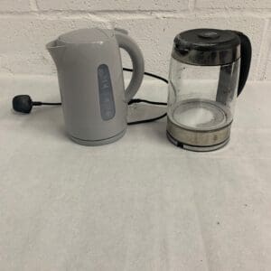 Two electric kettles, gray and glass.