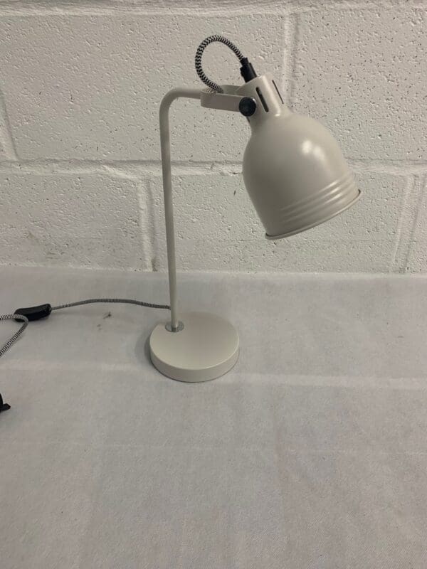 Light gray adjustable desk lamp.