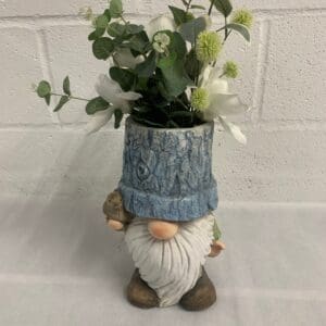 Gnome planter with flowers and bird.