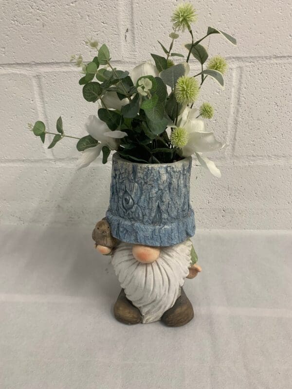 Gnome planter with flowers and bird.