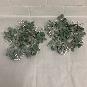 Two frosted greenery wreaths with berries.