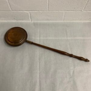 Antique copper warming pan with wood handle.